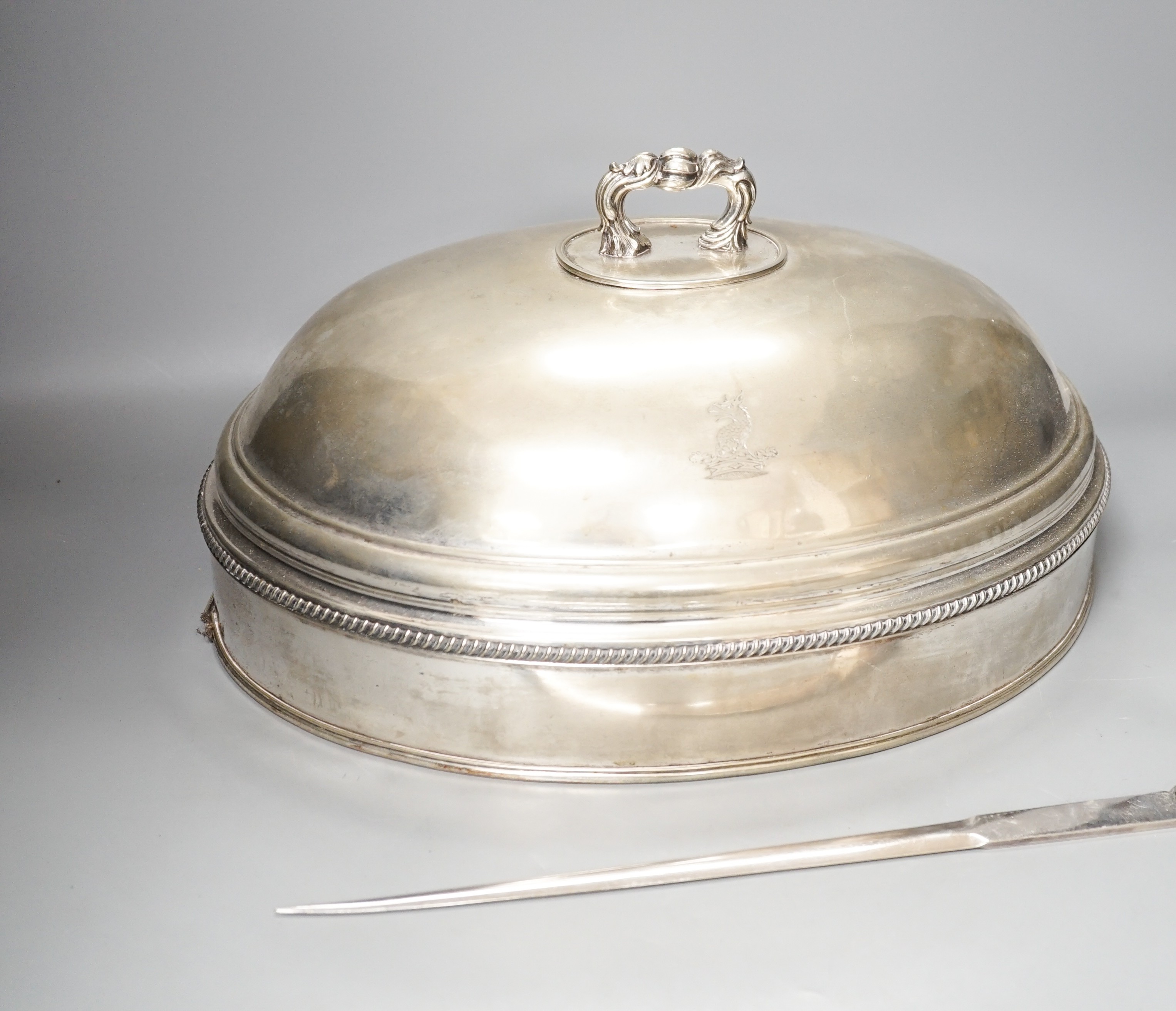 A silver plated cloche / meat cover and a plated meat skewer